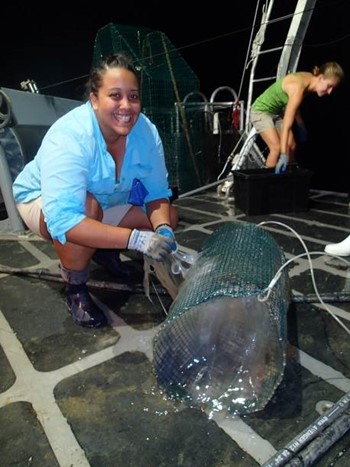 Graduate student Ale Mickle with a trap full of hagfish slime