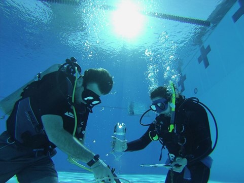 Figure 1. Student divers conduct a physics demonstration at Morcom Aquatics Center.