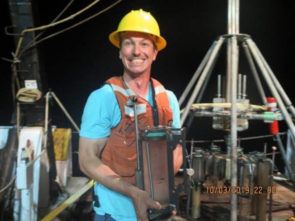 A very happy Dr. Ingels with a tube full of sediment. Image: Dr J. Ingels FSUCML